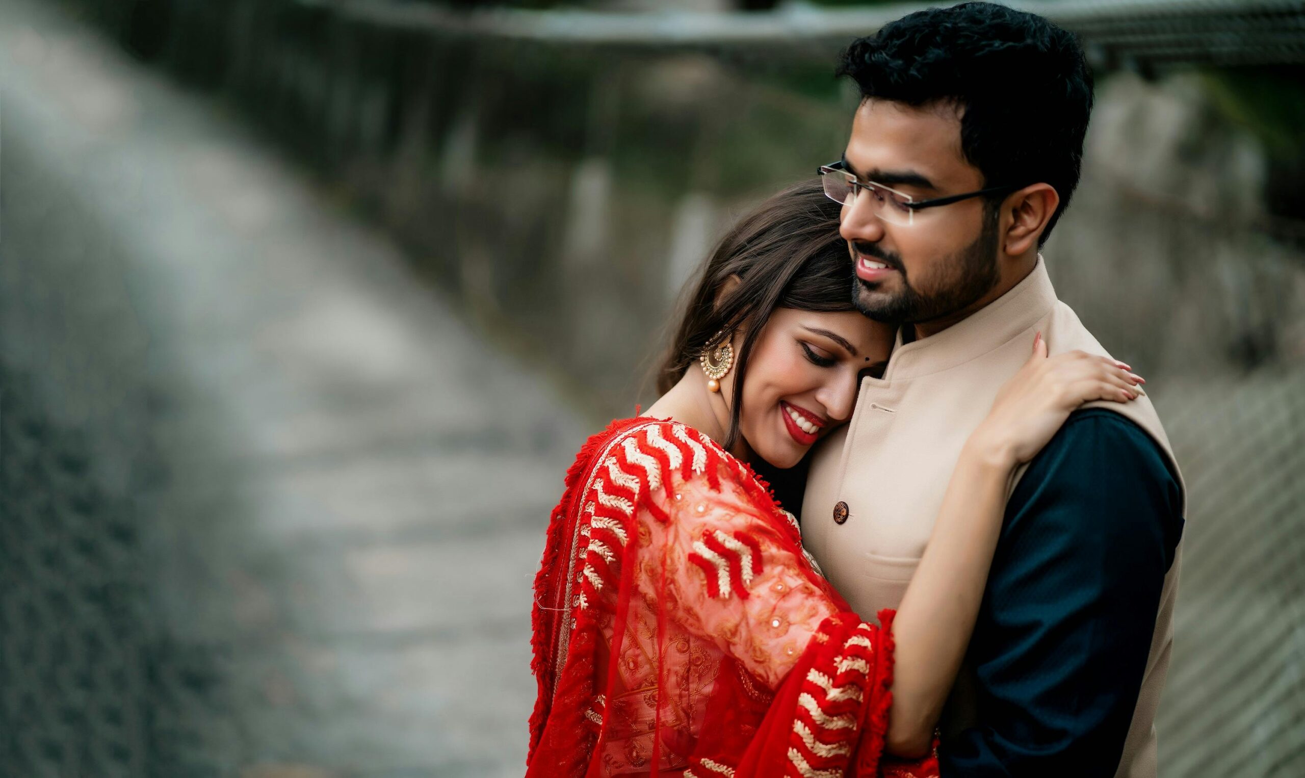 A happy couple embracing during an outdoor photoshoot, showcasing love and warmth in Delhi, India.